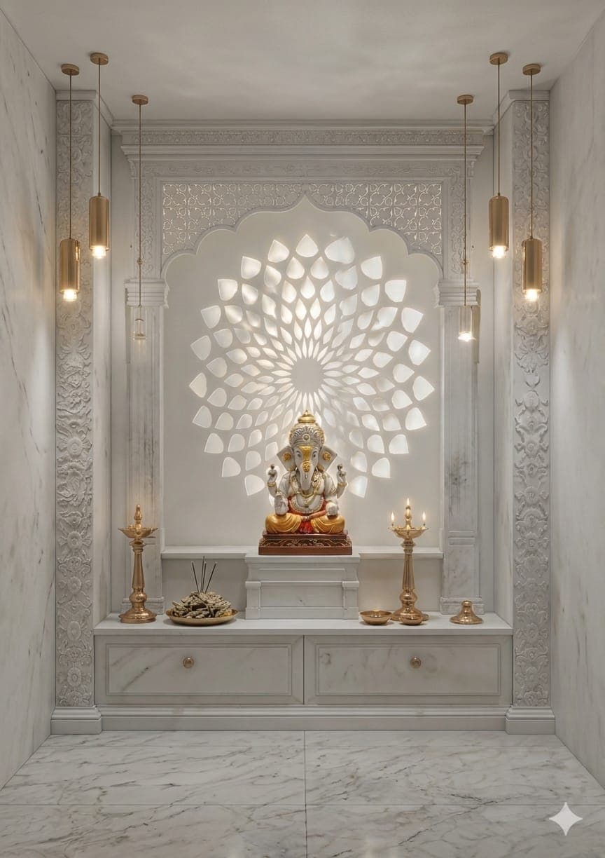 A clean white-marble pooja room with brass lamps